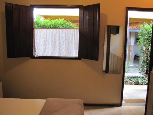 a door with a window in a room at Pousada das Bromélias in Serra do Cipo