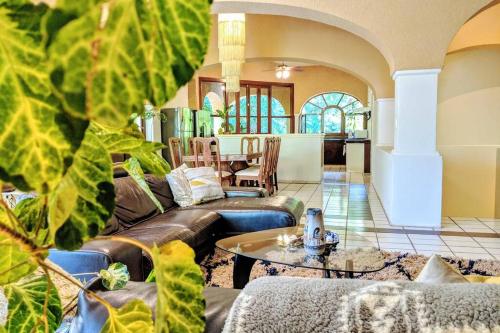 a living room with couches and a table at Steps to Ocean Huge Beach Villa Private Pool in Exclusive Fase 1 Playacar in Playa del Carmen