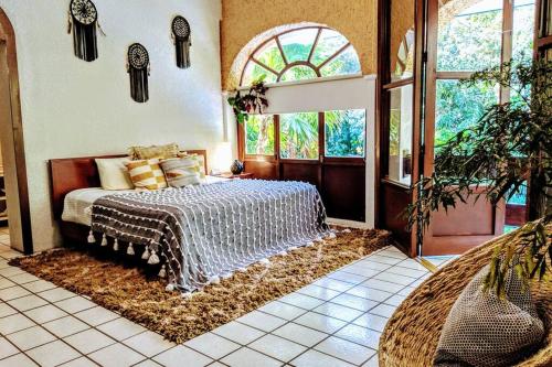 a bedroom with a bed and a large window at Steps to Ocean Huge Beach Villa Private Pool in Exclusive Fase 1 Playacar in Playa del Carmen