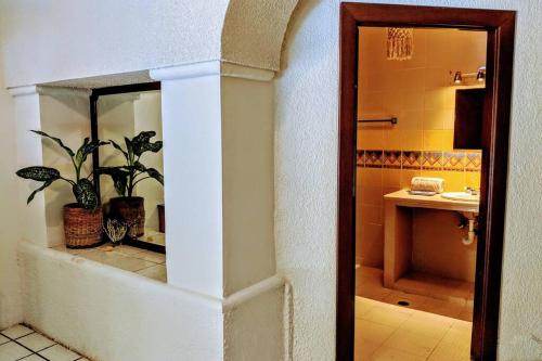 a bathroom with a sink and a toilet and a mirror at Steps to Ocean Huge Beach Villa Private Pool in Exclusive Fase 1 Playacar in Playa del Carmen