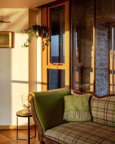 a living room with a couch and a window at Flint Barns, Rathfinny Wine Estate in Alfriston