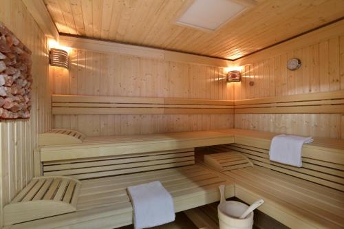 a wooden sauna with two chairs at The Originals City, Hôtel Les Thermes de l'Avenue, Dax in Dax