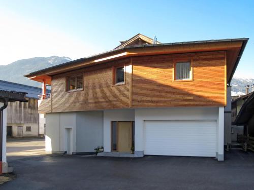 a house with a wooden roof and a garage at Apartment Nina by Interhome in Uderns