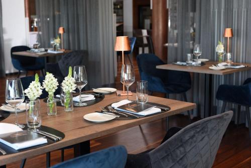 a dining room with tables and chairs with wine glasses at Schlossberg Hotel Homburg in Homburg