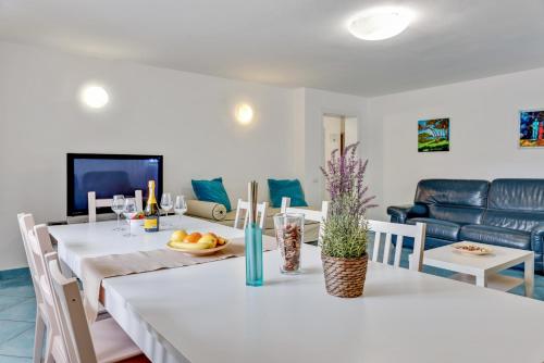 a dining room and living room with a table and chairs at InVilla Seristori, a 50 m dal mare in San Vincenzo
