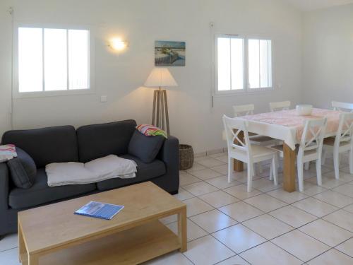 a living room with a couch and a table at Holiday Home Résidence Plage Océane - BPL341 by Interhome in Biscarrosse-Plage