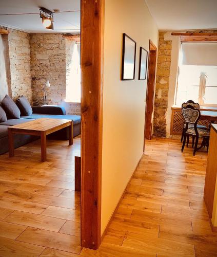 a living room with a couch and a table at Kohtu Apartment Unique in Kuressaare