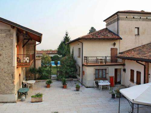 a courtyard in a house with tables and chairs at Holiday Home Villetta by Interhome in San Felice del Benaco