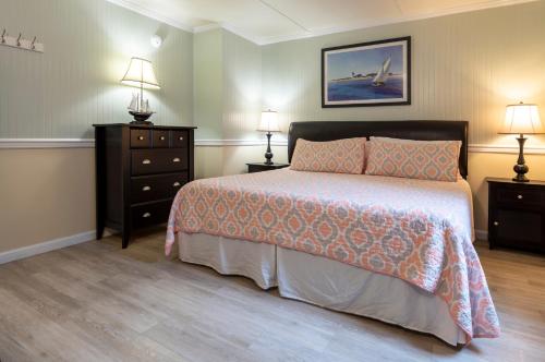 a bedroom with a bed with two night stands and two lamps at Blackbeard's Lodge in Ocracoke