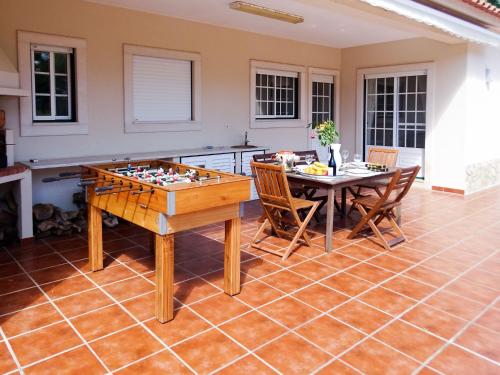 a living room with a table and a chess board at Holiday Home All Welcome - TOV120 by Interhome in Sobreiro Curvo