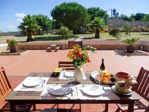 a wooden table with food and a bottle of wine at Holiday Home All Welcome - TOV120 by Interhome in Sobreiro Curvo