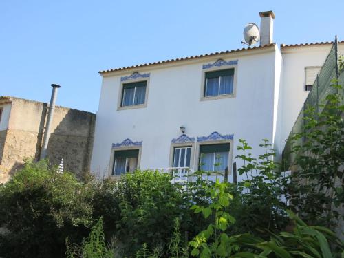 a white building with windows and bushes at Holiday Home Das Serradas by Interhome in Vau