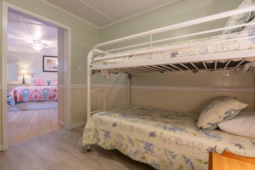 a bedroom with two bunk beds in a room at Blackbeard's Lodge in Ocracoke