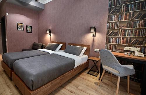 a bedroom with a bed and a desk at Hotel City in Tbilisi City