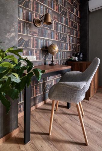 a desk with a chair and a plant in a room at Hotel City in Tbilisi City