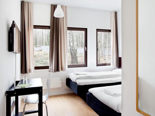 Säng eller sängar i ett rum på Hotell Dialog