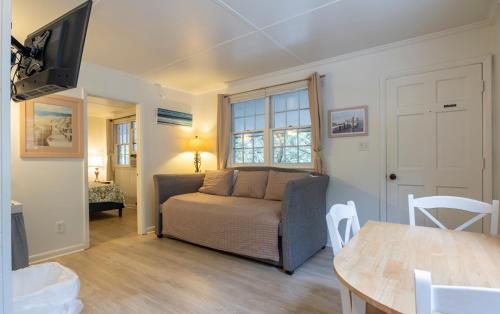 a living room with a couch and a table at Blackbeard's Lodge in Ocracoke