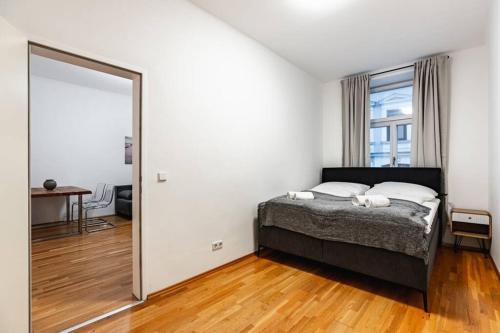 a bedroom with a bed and a large mirror at Spacious 3-room apt. 15 min to the city center in Vienna