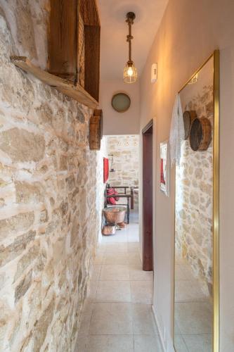 a hallway of a house with a stone wall at Zeus Traditional House in Mitrópolis