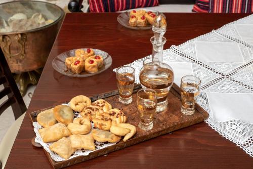 a table with a tray of food and a bottle of wine at Zeus Traditional House in Mitrópolis