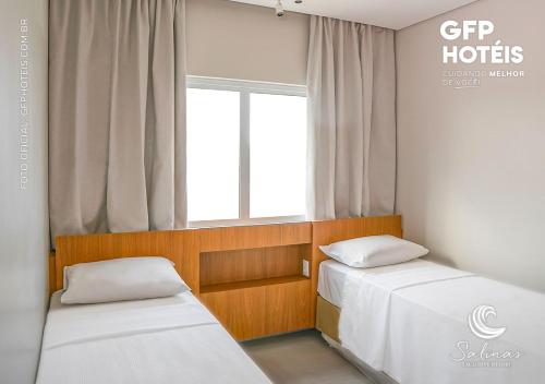 a room with two beds and a window at SALINAS EXCLUSIVE - GAV Resorts in Salinópolis