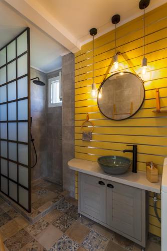 a bathroom with a sink and a mirror at Amoroza Villa in Nydri