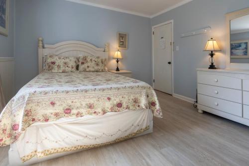a bedroom with a large bed and two night stands at Blackbeard's Lodge in Ocracoke