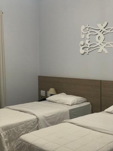 Katil atau katil-katil dalam bilik di Hotel D'Nápoles