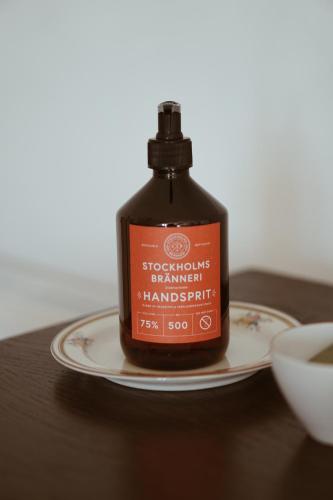 a bottle on a plate on a table at Axatorpsgården in Trelleborg