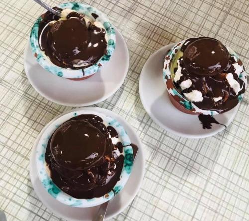 three bowls of chocolate cakes on plates on a table at La dimora di Clara in Trapani