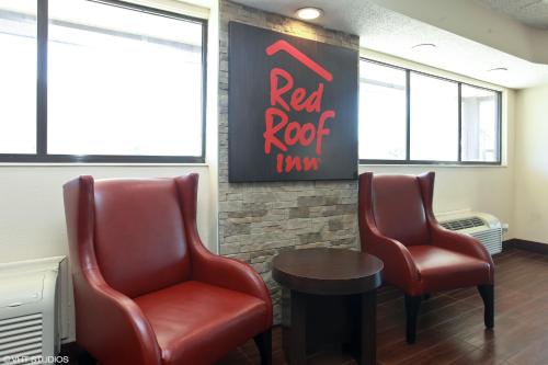 a waiting room with two chairs and a red roof inn sign at Red Roof Inn Michigan City in Michigan City