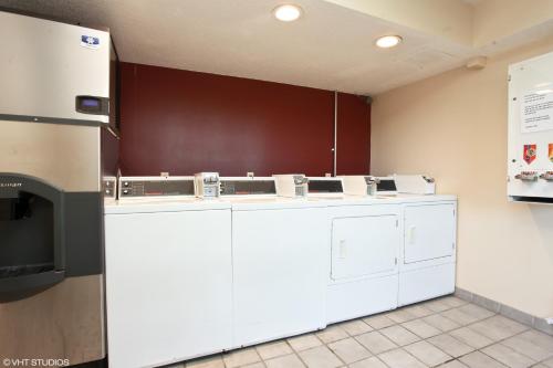 a kitchen with white appliances in a room at Red Roof Inn Michigan City in Michigan City