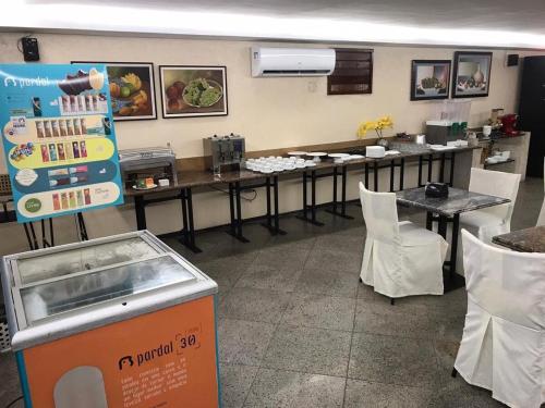a restaurant with tables and chairs in a room at 507 Lindo Flat mobiliado na Praia de Iracema in Fortaleza