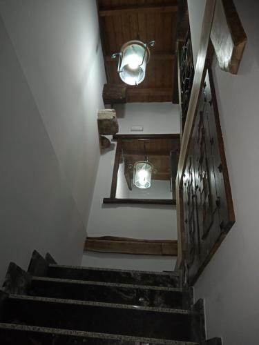 a stairway with a railing and lights on it at Albergue la Medina de Camponaraya in Camponaraya