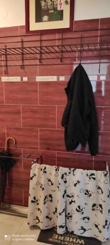 a pair of shorts and a black jacket hanging on a wall at TP Apartman 1 in Križevci