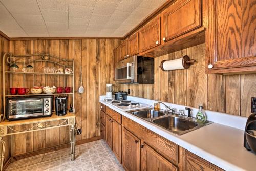 a kitchen with wooden cabinets and a sink at Secluded Ridgetop Hideaway with Valley Views! in Menlo