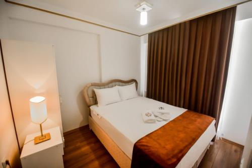 Ένα ή περισσότερα κρεβάτια σε δωμάτιο στο Rosa Therapy Butik Otel