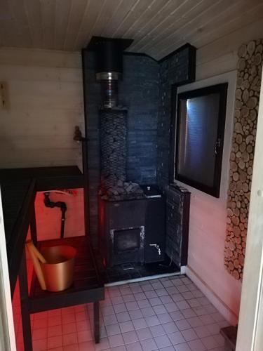 a small room with a stove in a house at Saviaugu majake Põlvamaal in Kärsa