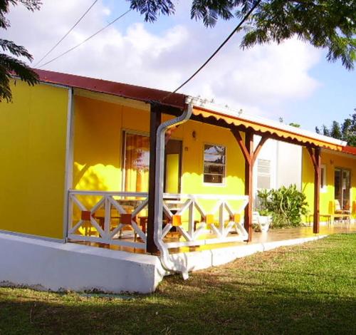 a yellow house with a red roof at Maison charmante Sainte-Luce in Sainte-Luce