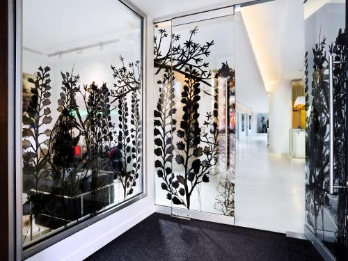 a room with glass doors with plants on them at The Chambers Hotel in Minneapolis