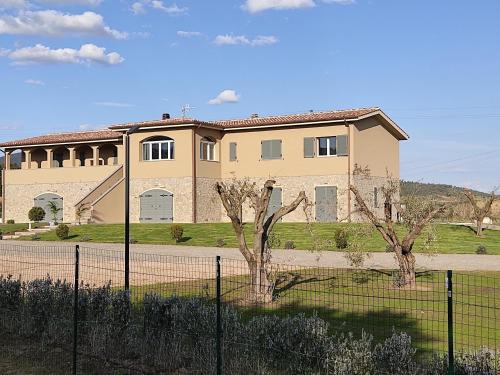 una grande casa con una recinzione di fronte di Sogni d'orto a Castiglione della Pescaia