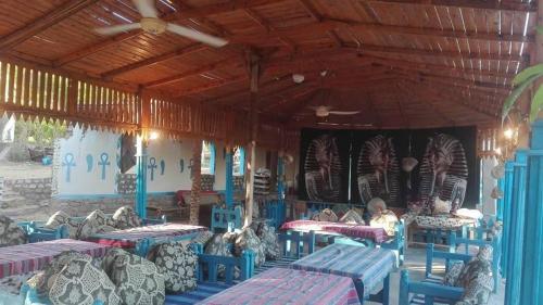 a group of tables and chairs in a restaurant at Nubian Farm Aswan in Aswan