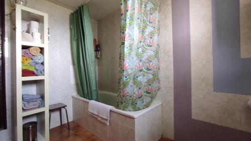 a bathroom with a shower with a shower curtain at Casa Sisco, dins de la Vall d'Àger in Ager