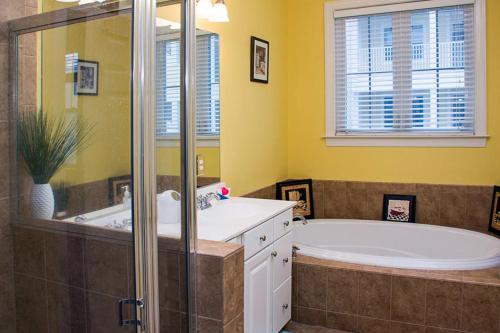 a bathroom with a large tub and a shower at Sunset Island - 3 Canal Side Mews in Ocean City
