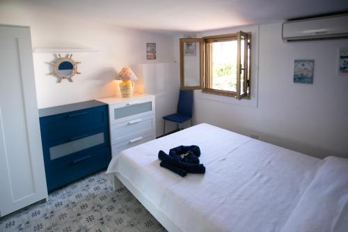 a bedroom with a bed with a hat on it at DilettaAnna sea view appartment in Tropea
