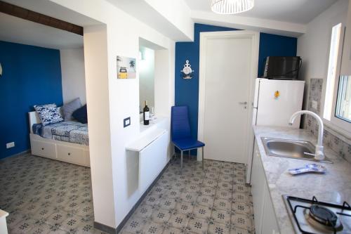 a small kitchen with a sink and a refrigerator at Stromboli sea view apartment in Tropea