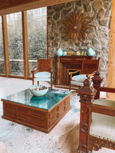 a living room with a coffee table and a stone wall at Leonera Hotel in La Leonera