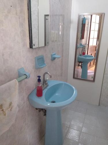 a bathroom with a blue sink and a mirror at Hostal Don Felipe in Guadalajara