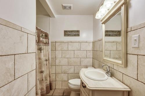een badkamer met een wastafel, een toilet en een spiegel bij Time-N-Tide 7 in Ocean City
