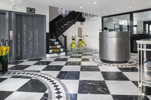 a black and white checkered floor in a room with bikes at Staypineapple, A Delightful Hotel, South End in Boston